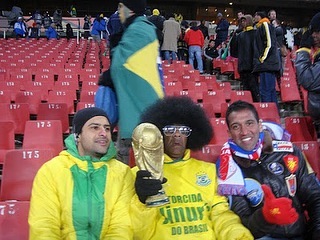 Day 5-Samba in the ColdFrrrrrrrrrrrrrreeeeeeeeeeeeezing Cold in JHB.I MEAN FRRRRRRRREEEEEEZING.At least for me. I’d say the coldest day of the World CupTomorow being a public holiday everyone was gearing up for the Brazillians to make their debut against North Korea.Samba in the cold.I bailed out on Moe and Oz and so did Killa.We went to Sandton.Saw 3D technology in Sandton Square.Did some business from Melrose Arch to Sandton.Met some fans..Ready to party Hondurans…learnt about Honduras and myself and Killa had a nice supper and headed home to regroup for the big one in Loftus against Uruguay.Moe and Oz braved the freezing cold in perhaps one of the coldest nights of the World Cup.Mo and Oz headed to Ellis Park. Trust our guys to find the creators.The Chap above is the main fan of the Brazillian supporters.Im sure you recognise him. They witnessed a fight between rival Brazilian supporters Corinthians and Sao Paulo. Brazil beat the Koreans 2-1. And I say again it was COOOOLLLD. Im sure Brazil were happy to get a victory in a tricky cold tie. But anything less would have been a tragedy.