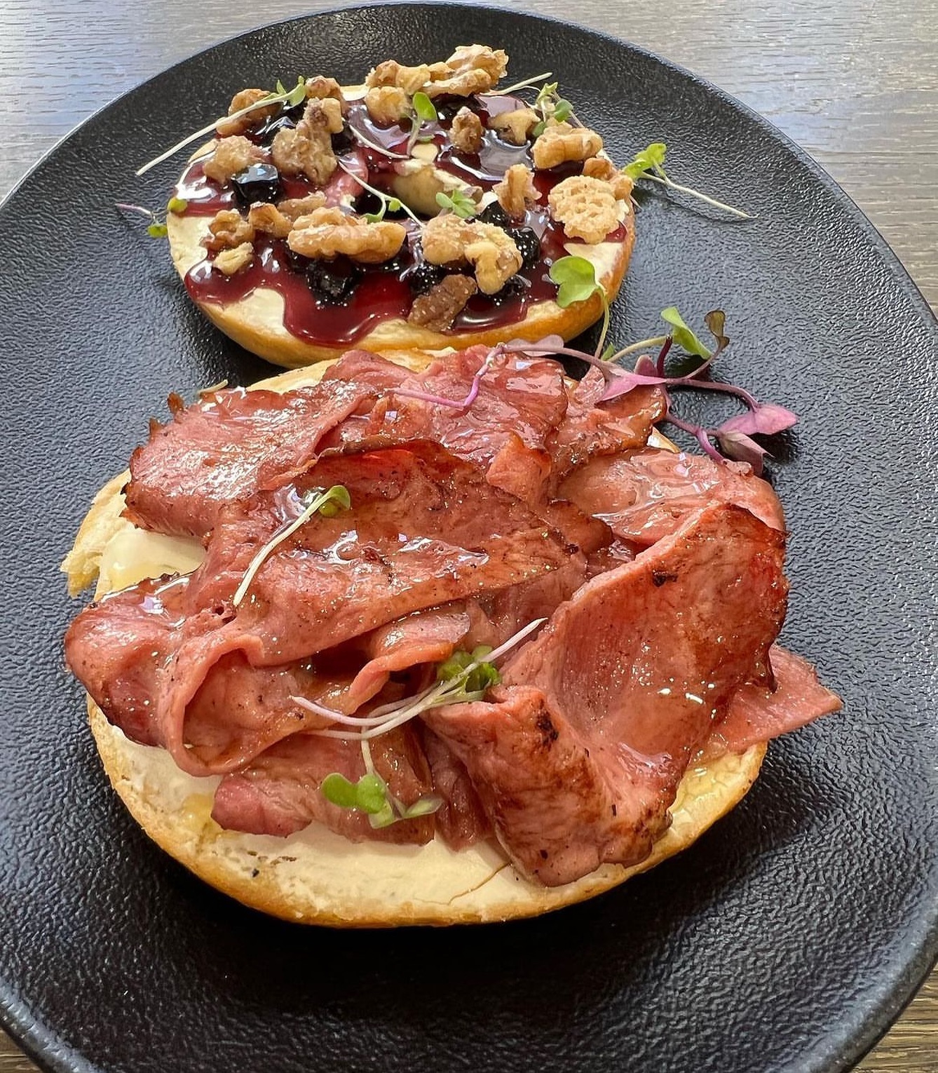 Early Morning breakfast Bagel  at @muggandbean_killarney  Macon & Blueberry Bagels 🥯 ️Buttered and Toasted Bagel, cream cheese, beef macon, blueberry & Vanilla Coulis, candied walnuts and honeyHave you tried this
