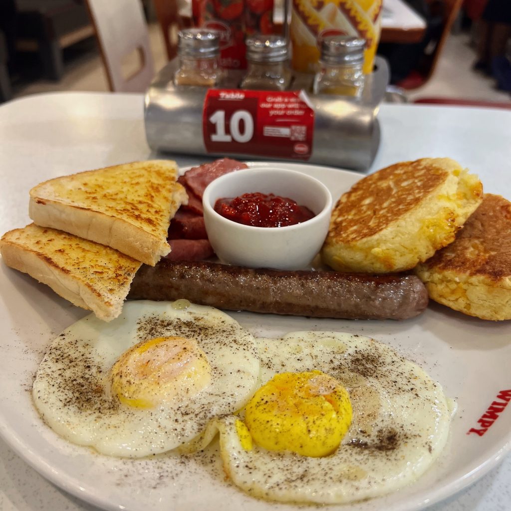 “Lekker Breakfast” at Wimpy Killarney Mall @wimpykillarney . 2 eggs, 3 slices smoked beef, beef boerewors, 2 cheese and sweet corn mealie bread flapjacks served with famous wimpy relish and toast