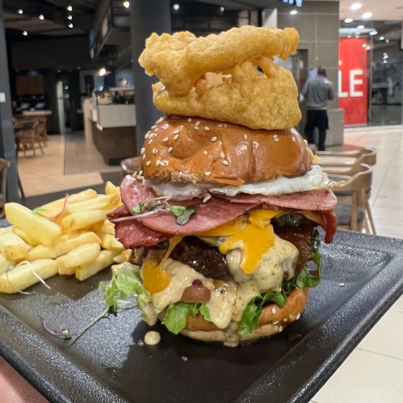 Knocked a Big Daddy Burger at Mugg and Bean Killarney since Im still here.Served on a sesame brioche bun°, with rosemary-salted skin-on fries, sweet potato fries or a side salad. Gherkins, tomato, burger mayo, red onion & lettuce. With a fried egg, beef macon, pastrami & cheddar. Topped with battered onion rings.#bestburger #bigdaddyburger #halaalmuggandbean #muggandbeankillarney #monsterburgers